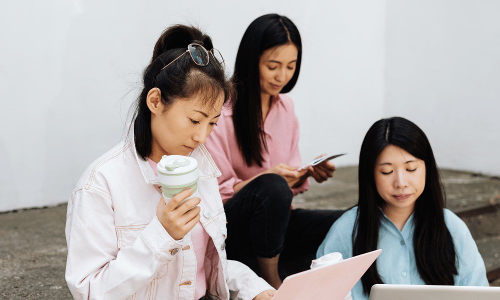 Chinese millennial professionals using laptops and mobile devices