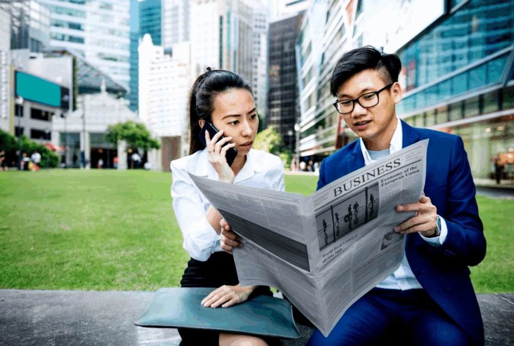 Business people reading the newspaper