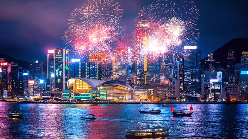 Fireworks over Victoria Harbour during a Hong Kong public holiday, illustrating large-scale celebrations that drive tourism and consumer spending.