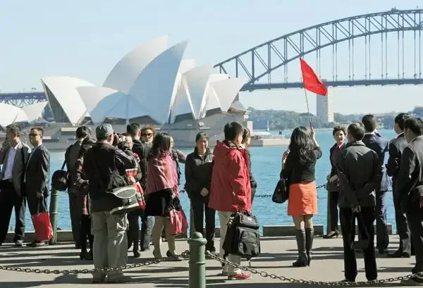 Chinese tourists group visiting Sydney Opera House