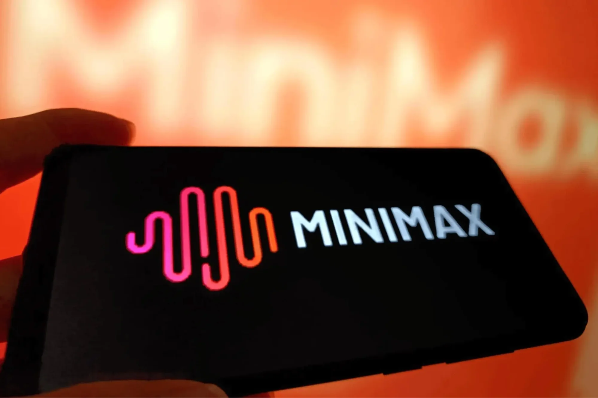 Close-up of MiniMax AI logo on smartphone screen with glowing background representing artificial intelligence branding