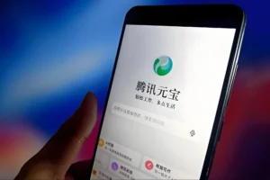 Smartphone displaying Tencent Yuanbao AI assistant app with chat interface and tools for writing, Q&A, and productivity tasks