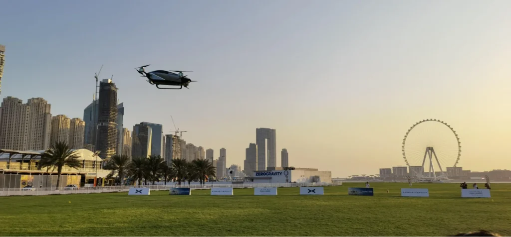 XPeng flying car operating over urban skyline at sunset highlighting low-altitude mobility and smart city integration