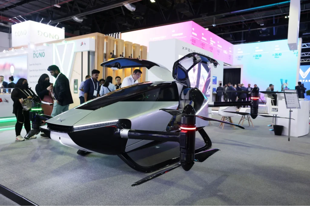 XPeng AeroHT flying car prototype displayed at technology exhibition with open canopy and visible eVTOL rotor system