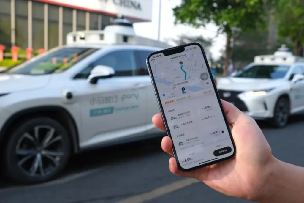 Smartphone displaying Pony AI robotaxi booking app with route and fare details for autonomous ride