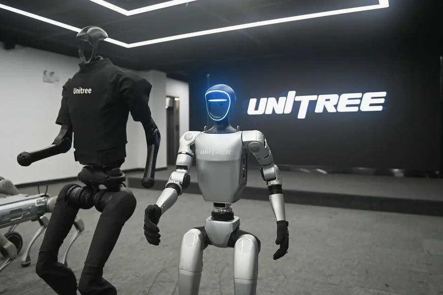 Unitree humanoid robots displayed inside showroom highlighting design and movement