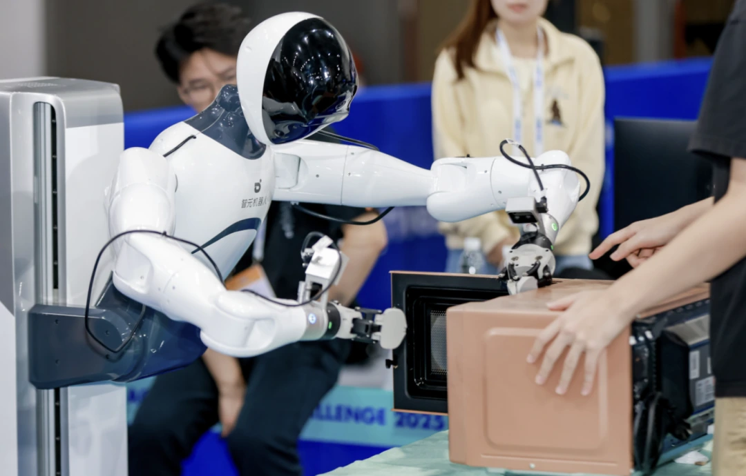 AgiBot humanoid robot demonstrating real-world object handling.