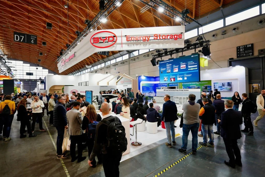 Large BYD Energy Storage exhibition stand with visitors exploring grid-scale and residential battery solutions.