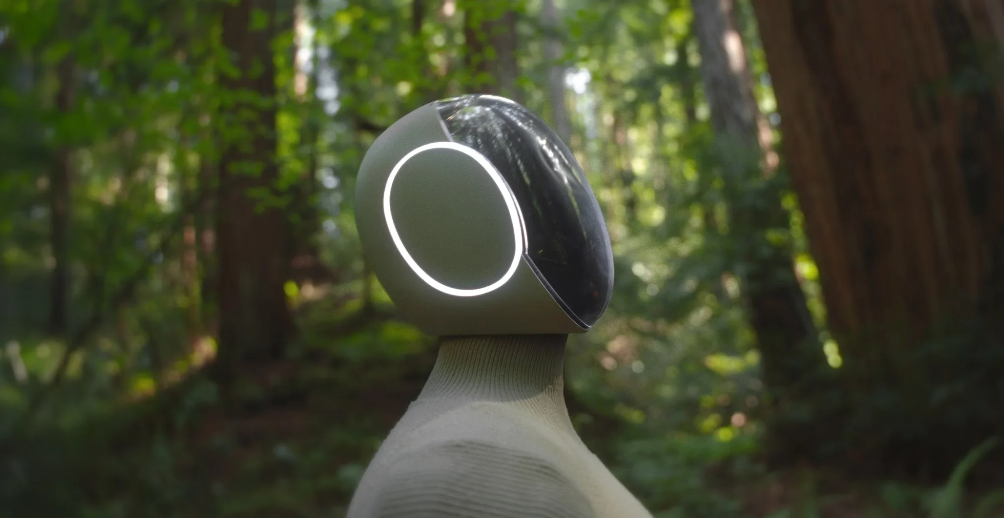 Close-up view of the NEO humanoid robot head and illuminated circular interface in a forest setting