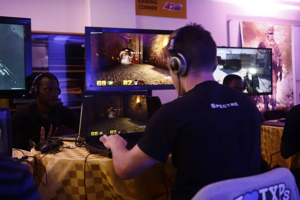 Players gaming on multiple screens in a competitive multiplayer environment