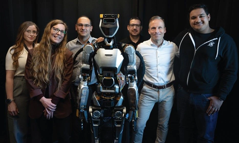 Sanctuary AI team posing with the Phoenix humanoid robot platform.