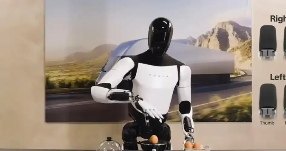 Tesla Optimus robot demonstrating hand movement and object handling during a robotics display