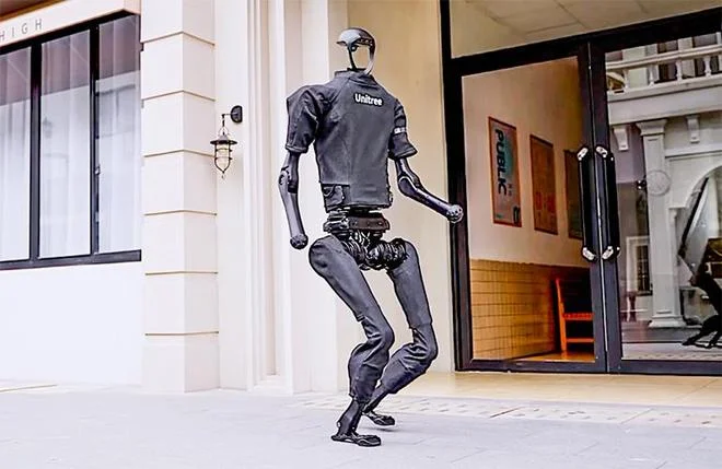 Unitree humanoid robot walking outdoors demonstrating balance and mobility