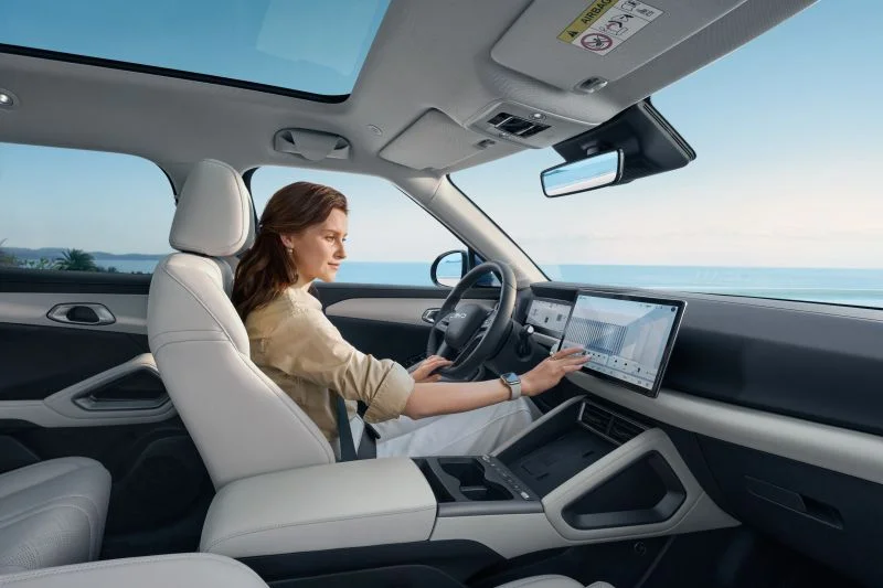 Woman using touchscreen inside a modern BYD electric vehicle cabin