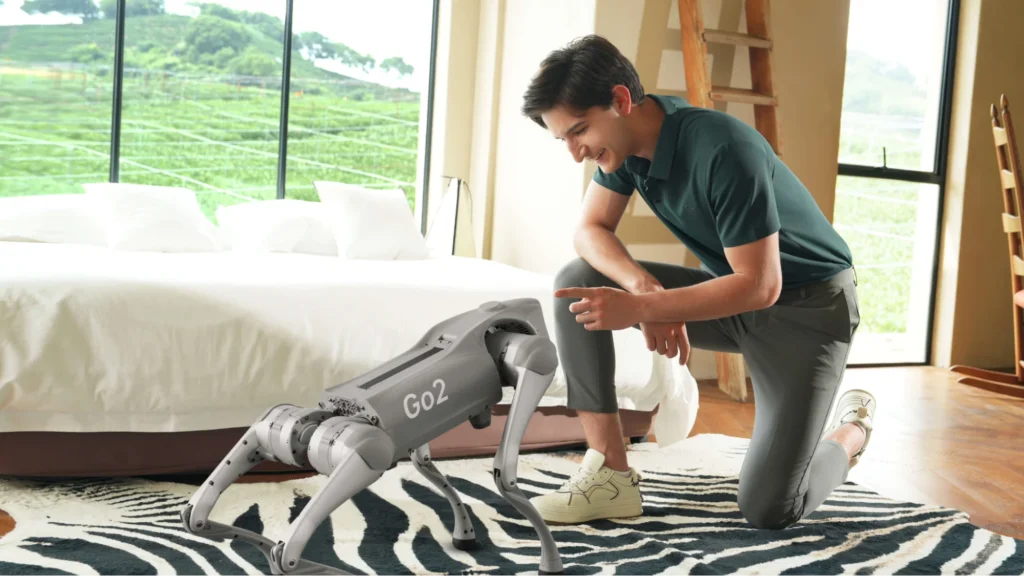 Person interacting with quadruped robot inside home showcasing human-robot interaction