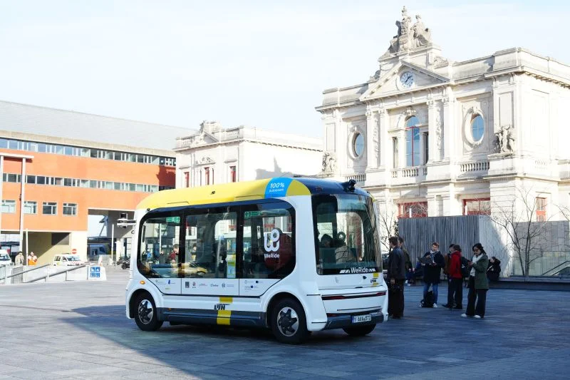WeRide autonomous robobus operating in European city square with passengers nearby