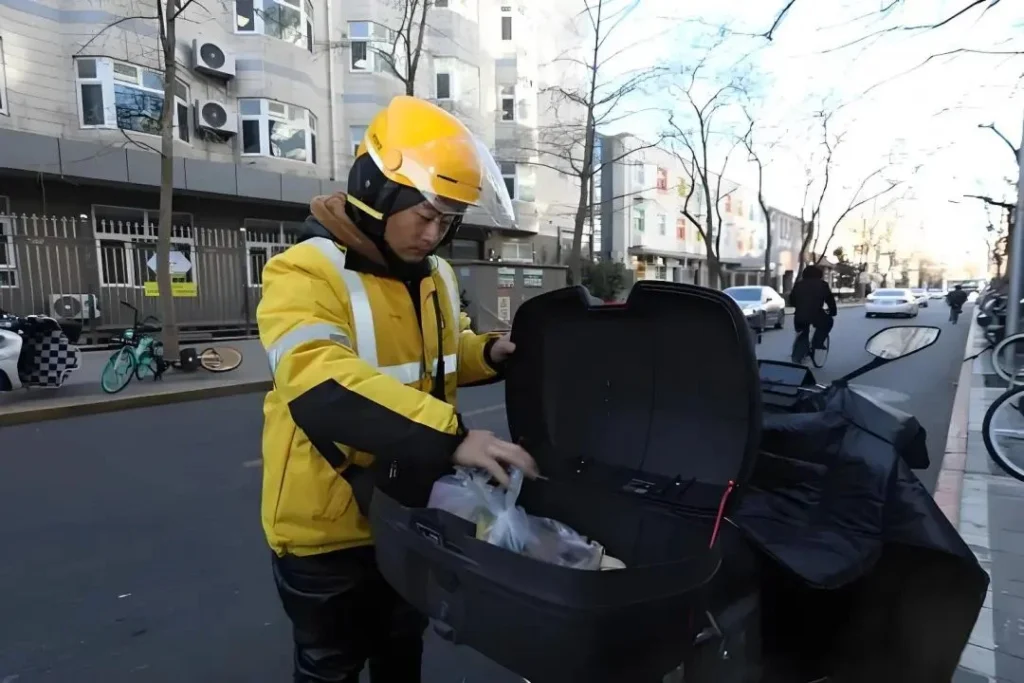 Meituan delivery rider preparing order for dispatch showing real-world food delivery operations