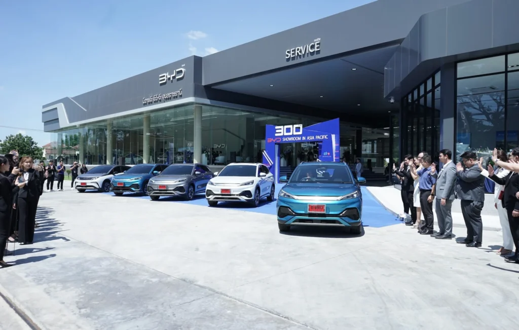 BYD showroom event displaying multiple electric cars with people gathered outside