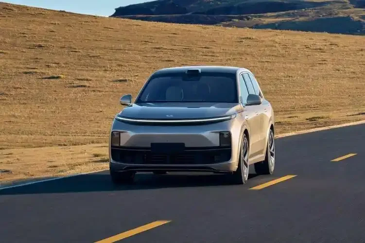 Li Auto SUV driving on open highway through rural landscape