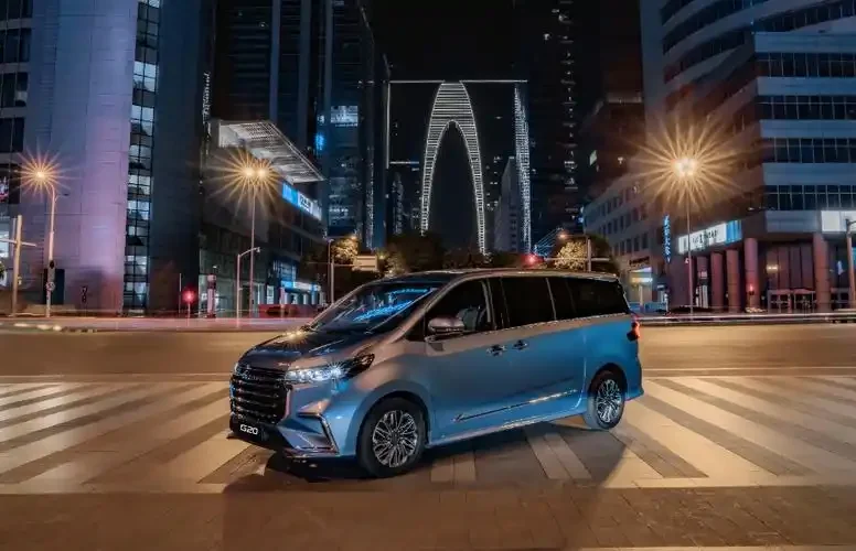 SAIC Maxus G20 multi purpose vehicle driving through a city at night