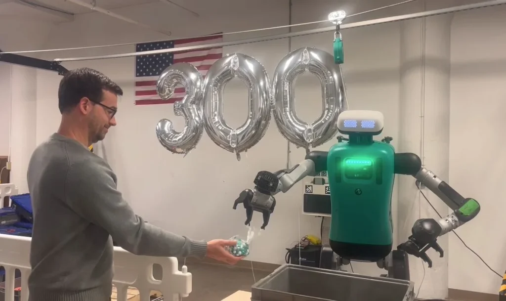Agility Robotics' Digit robot interacting with a person during a demonstration marking a major operational milestone.