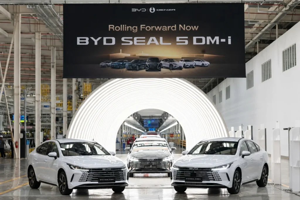 BYD Seal 5 DM-i vehicles displayed inside a modern automotive production facility.