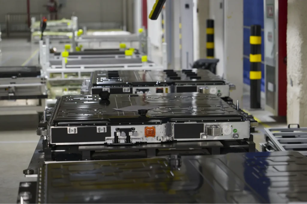 EV battery packs moving along a factory assembly line