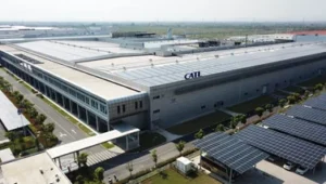 Exterior view of a CATL battery manufacturing facility with rooftop solar panels and large-scale industrial infrastructure in China.