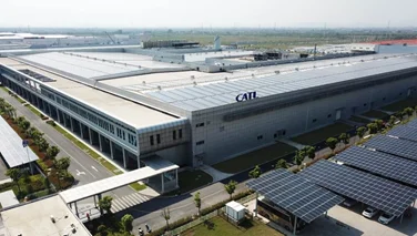 Exterior view of a CATL battery manufacturing facility with rooftop solar panels and large-scale industrial infrastructure in China.