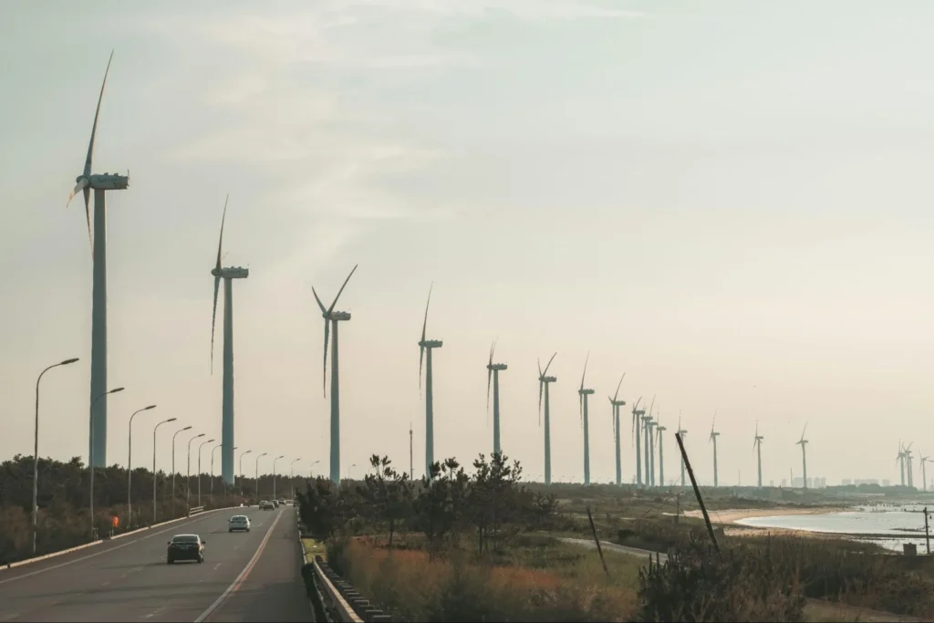 Onshore wind farm beside a coastal highway