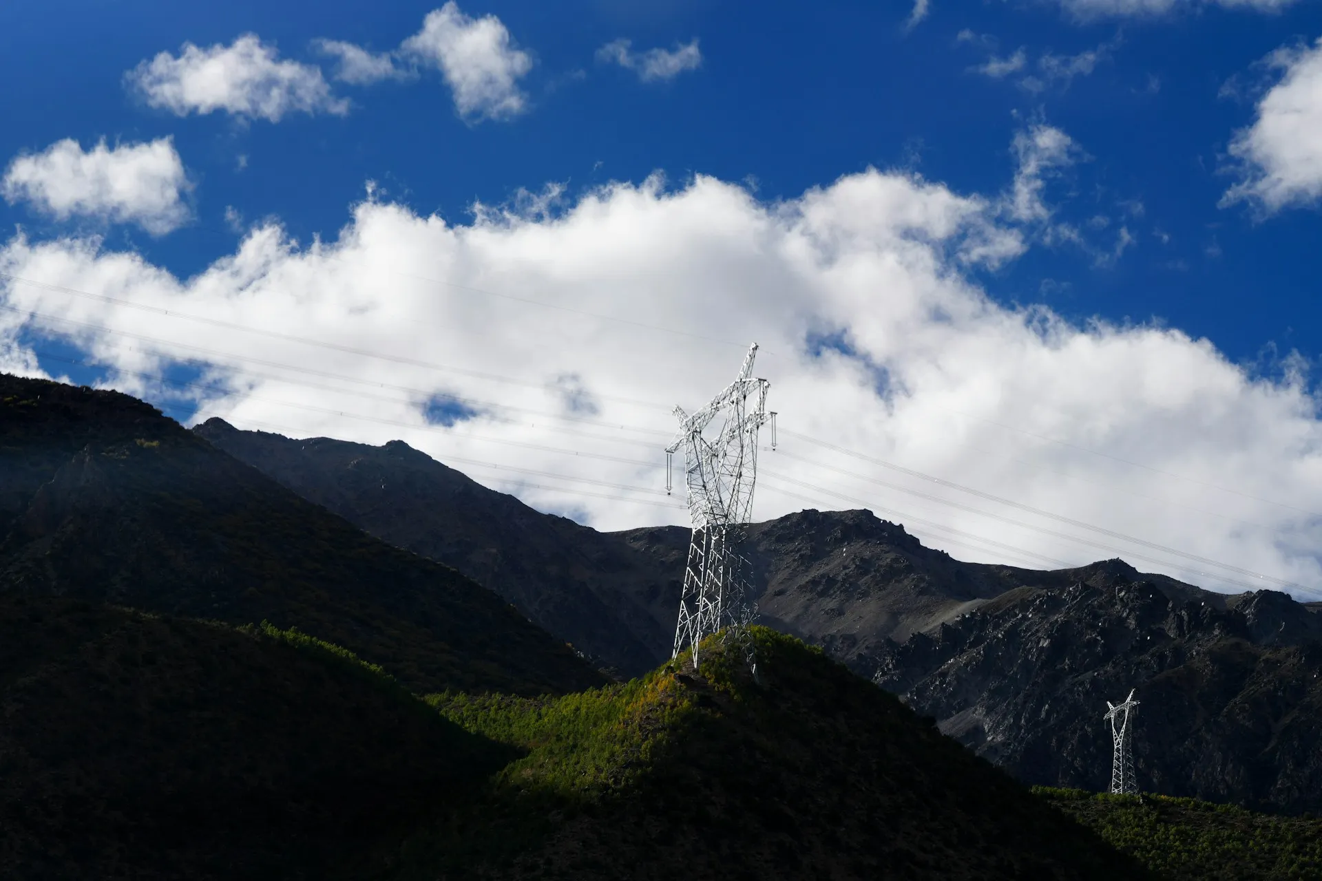 High-voltage transmission lines in a mountain landscape