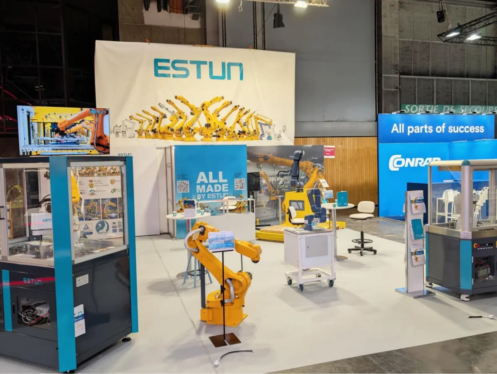 ESTUN robotics display booth featuring multiple yellow industrial robotic arms at an expo.