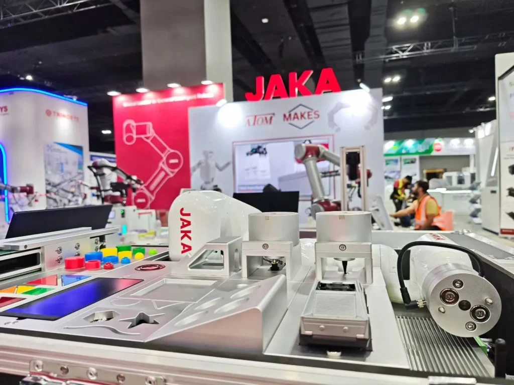 JAKA collaborative robot demonstrating automated assembly tasks at trade show.
