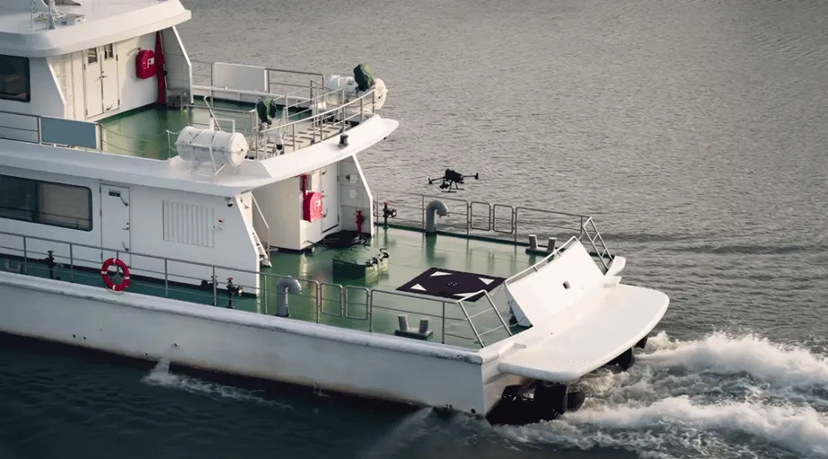 Drone inspecting a moving vessel at sea