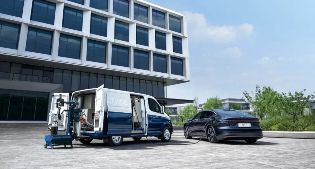 NIO electric car charging beside service van
