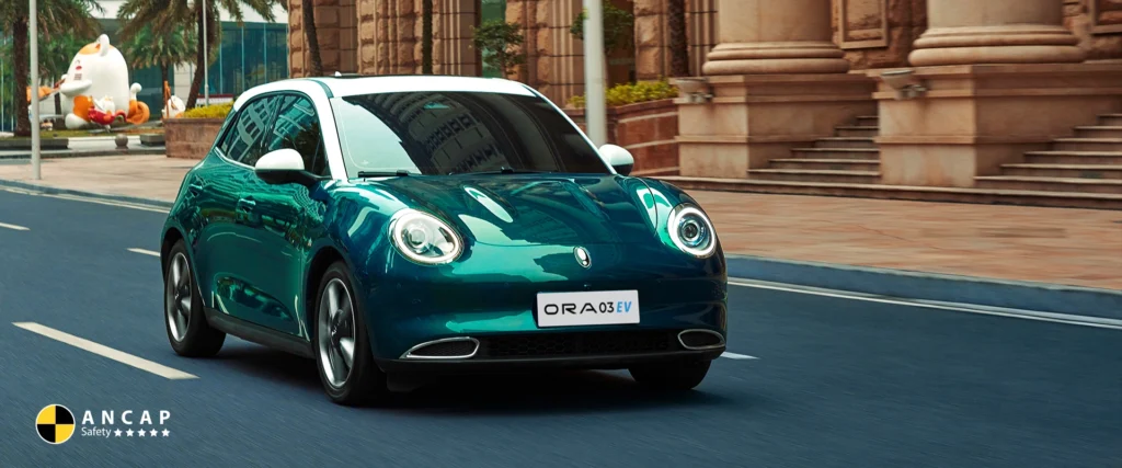 Green ORA 03 EV driving on city road