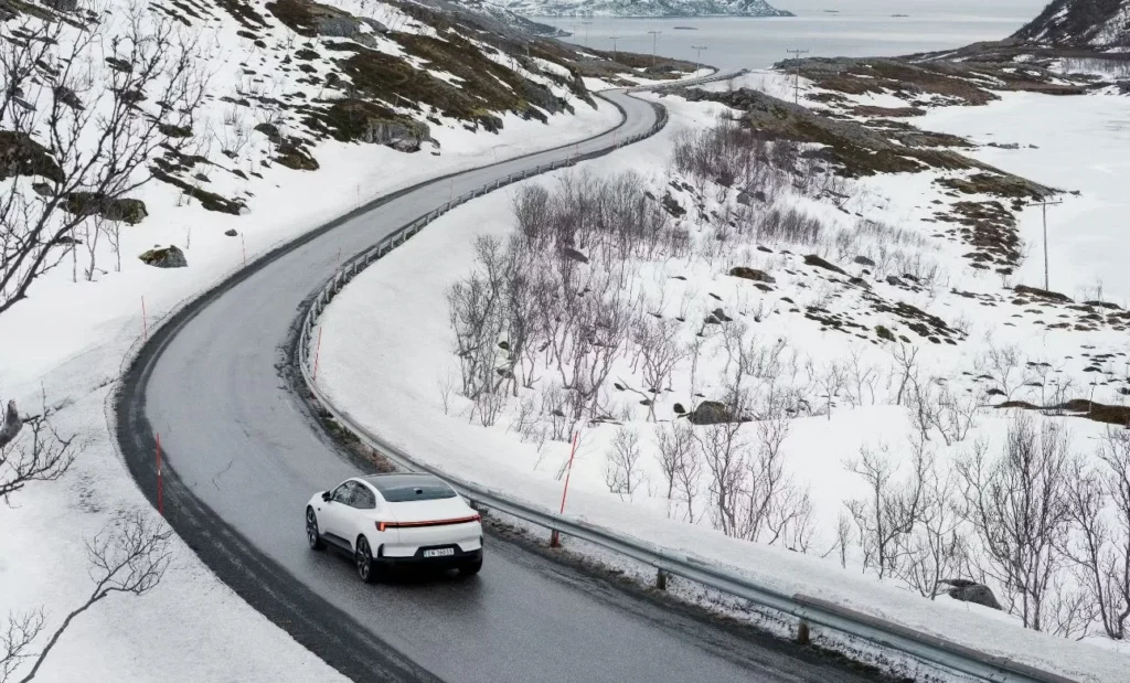 Polestar electric vehicle driving through a snowy landscape, reflecting Geely’s premium global EV portfolio