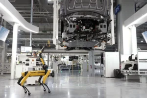 Quadruped robot inspecting a modern automotive production line