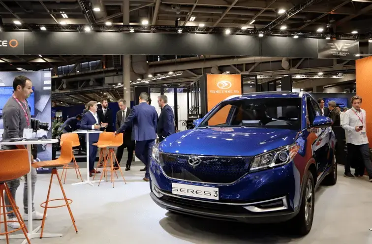 Blue SERES 3 SUV displayed at an auto expo with visitors examining the vehicle.