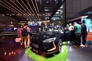Black SERES SUV showcased at indoor motor show with visitors exploring the car