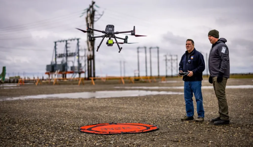 Operators flying drone near electrical substation