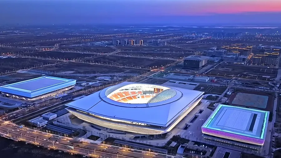 Xiongan sports stadium and modern urban district at night