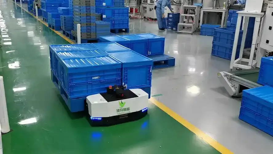 AGV transporting blue containers on factory floor