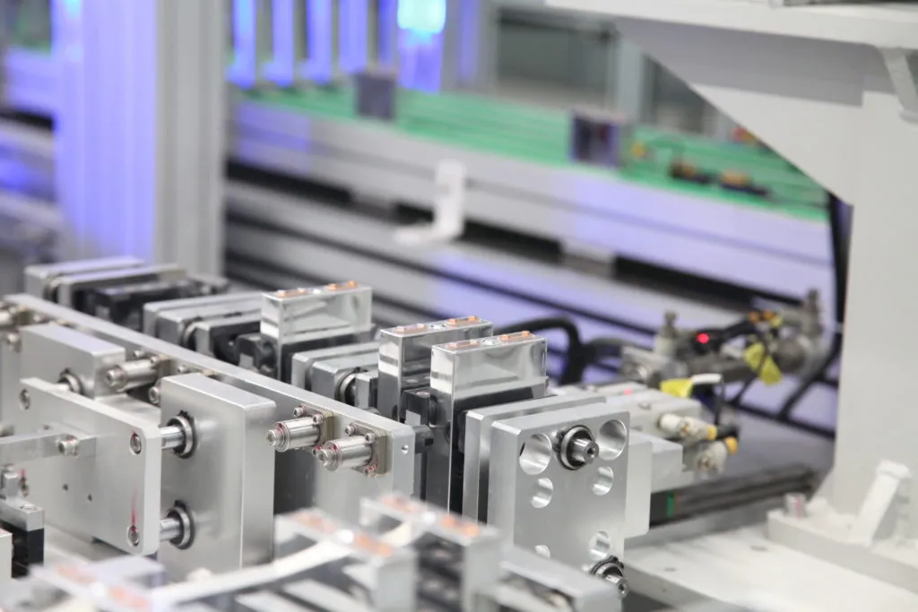 Battery cells moving through automated assembly equipment