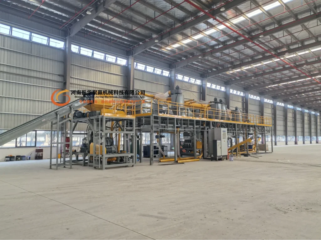 Large battery recycling machinery in an industrial plant