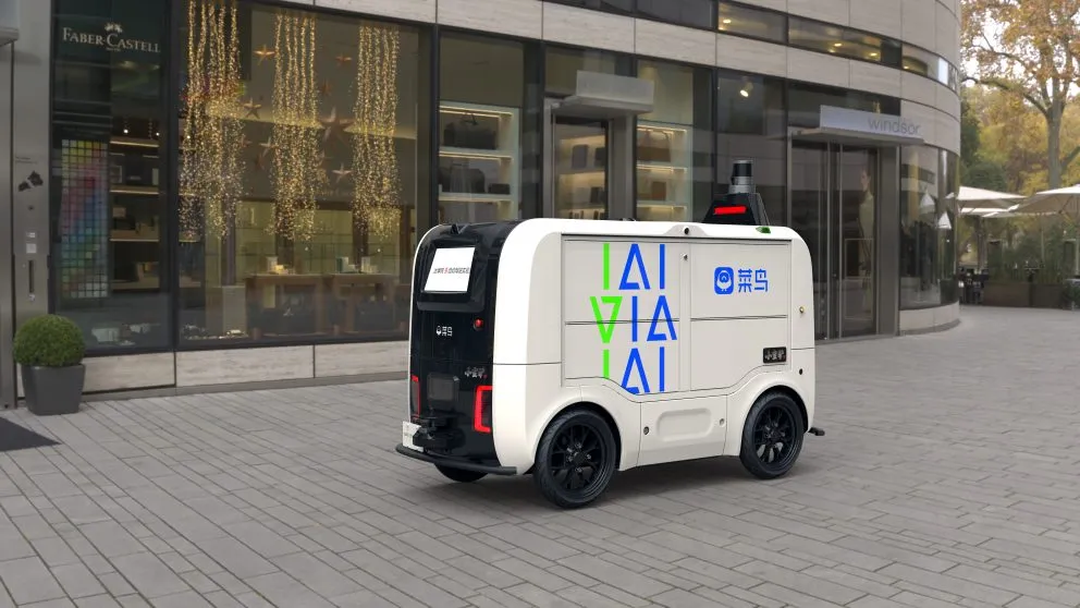 White delivery robot outside shopping area