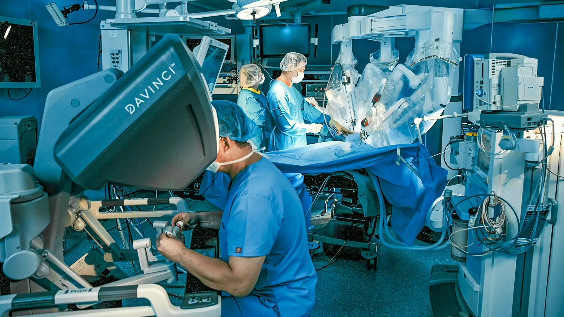 Robotic arms assisting surgeons during minimally invasive surgery.