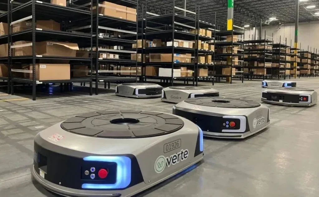 Geek+ robots working under warehouse shelving