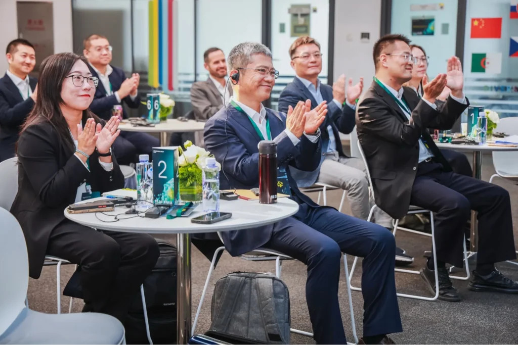 Business attendees applauding during a Gotion event