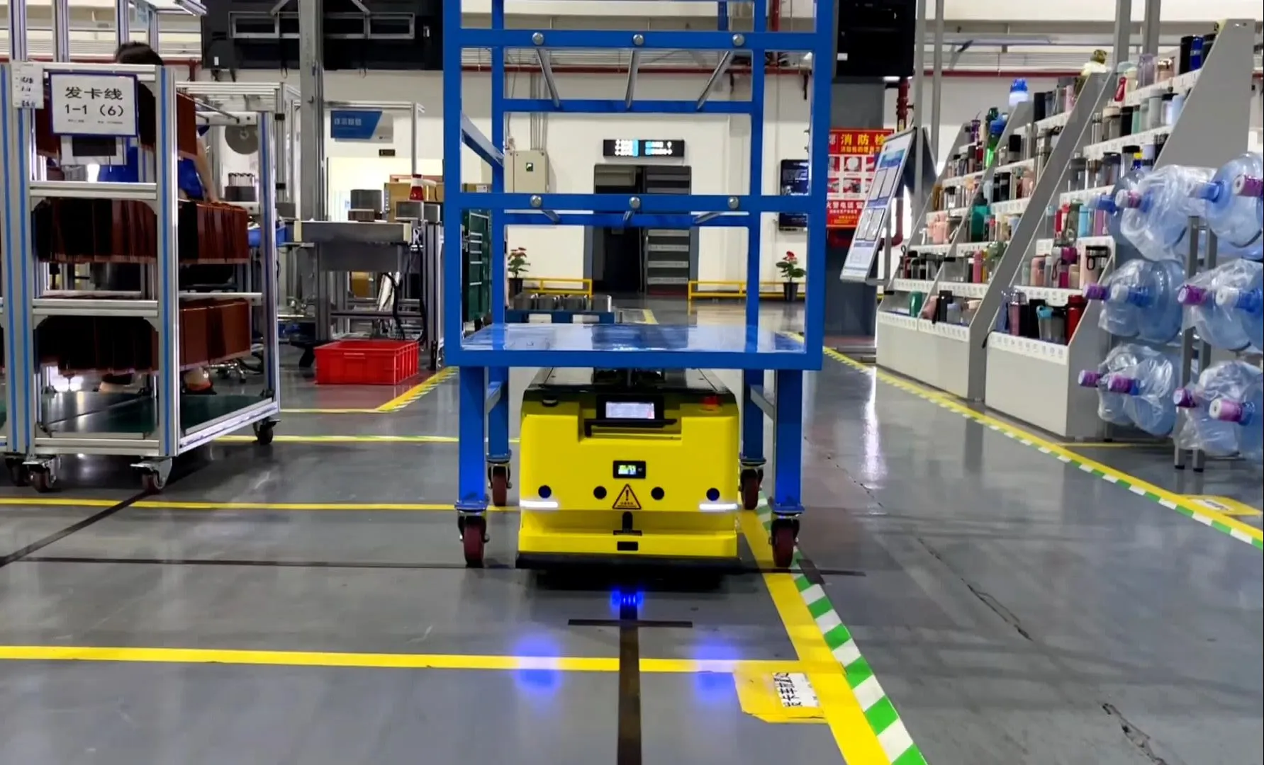 Yellow AGV moving a cart on factory guide path